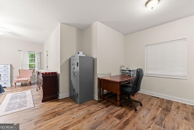 791 Thornwood Cir, Mount Airy, GA 30563 - office area featuring light wood-style flooring, a textured ceiling, and baseboards
