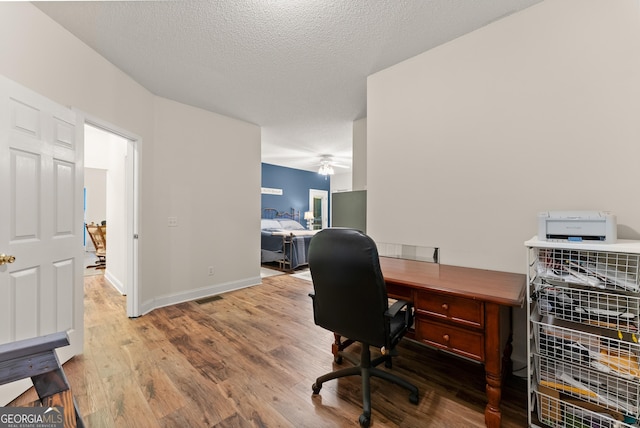 791 Thornwood Cir, Mount Airy, GA 30563 - office featuring wood finished floors, ceiling fan, baseboards, and a textured ceiling