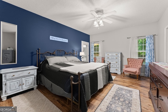 791 Thornwood Cir, Mount Airy, GA 30563 - bedroom with light wood-style floors, a textured ceiling, and a ceiling fan