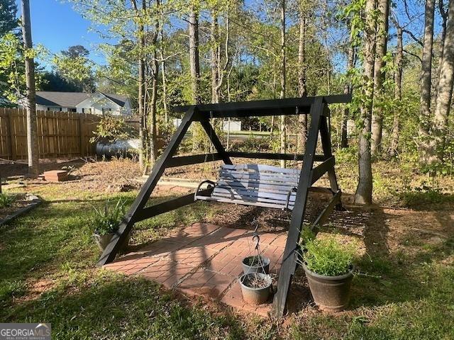 791 Thornwood Cir, Mount Airy, GA 30563 - view of green lawn featuring an outdoor fire pit and a deck