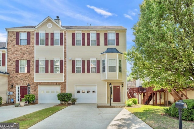 745 Abbotts Mill Ct, Duluth, GA 30097 - townhome / multi-family property featuring a chimney, driveway, a garage, and stairs