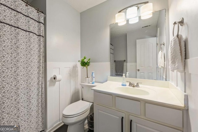 745 Abbotts Mill Ct, Duluth, GA 30097 - bathroom with visible vents, toilet, tile walls, vanity, and wainscoting