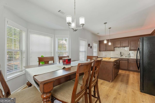 745 Abbotts Mill Ct, Duluth, GA 30097 - dining space featuring light wood finished floors, visible vents, and an inviting chandelier