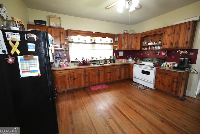 3002 24th Ave, Valley, AL 36854 - kitchen featuring freestanding refrigerator, open shelves, white electric range, and brown cabinets