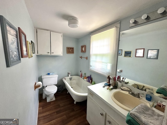 3002 24th Ave, Valley, AL 36854 - bathroom with wood finished floors, toilet, a freestanding bath, and vanity