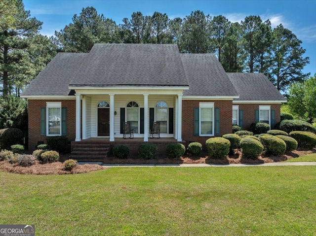 485 Fussell Rd, Leesburg, GA 31763 - neoclassical / greek revival house featuring roof with shingles, covered porch, a front yard, and brick siding