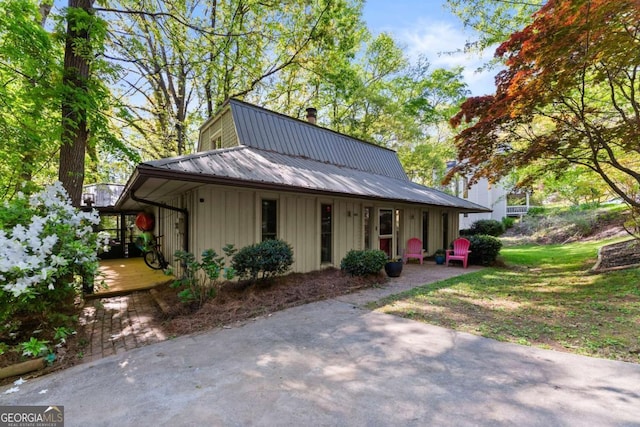 country-style home with board and batten siding and metal roof