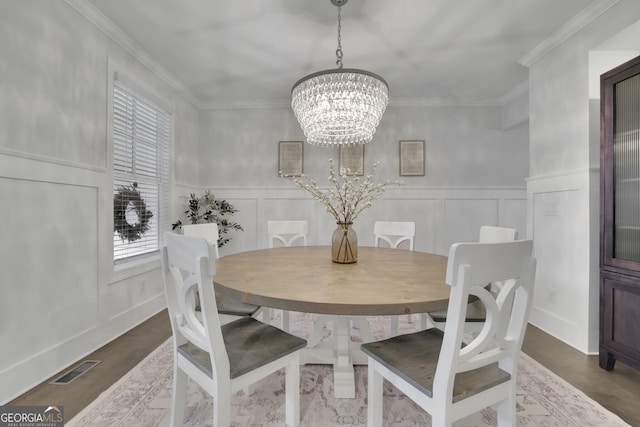 123 Townsend Pass, Alpharetta, GA 30004 - dining room featuring a decorative wall, a chandelier, crown molding, wood finished floors, and a wainscoted wall