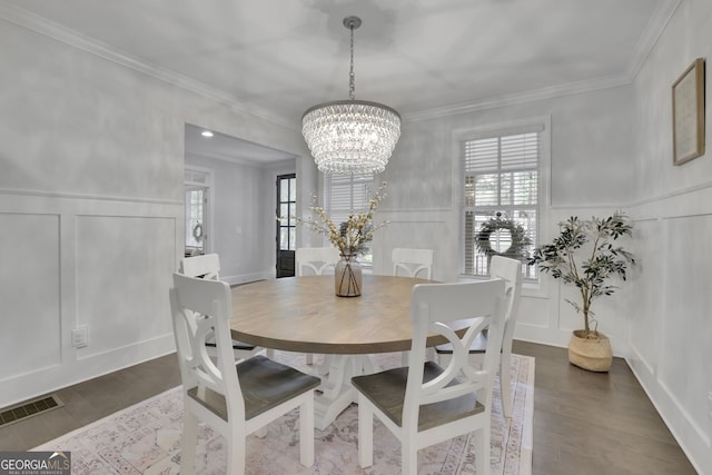 123 Townsend Pass, Alpharetta, GA 30004 - dining area featuring a decorative wall, healthy amount of natural light, a chandelier, crown molding, and dark wood finished floors