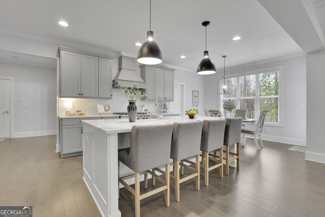 123 Townsend Pass, Alpharetta, GA 30004 - kitchen with custom range hood, gray cabinets, light countertops, a kitchen breakfast bar, and recessed lighting