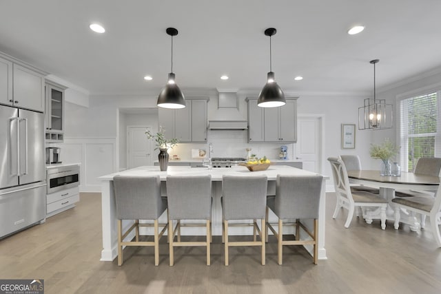 123 Townsend Pass, Alpharetta, GA 30004 - kitchen featuring stainless steel appliances, gray cabinetry, a kitchen bar, crown molding, and recessed lighting