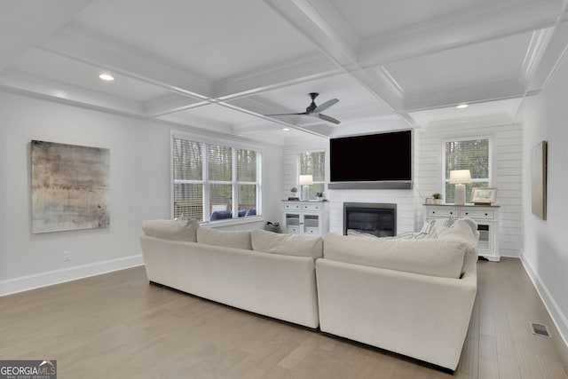 123 Townsend Pass, Alpharetta, GA 30004 - living room featuring a glass covered fireplace, ceiling fan, beamed ceiling, wood finished floors, and recessed lighting
