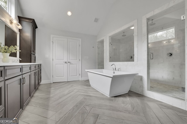 123 Townsend Pass, Alpharetta, GA 30004 - bathroom featuring a shower stall, vanity, vaulted ceiling, a soaking tub, and recessed lighting
