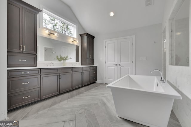 123 Townsend Pass, Alpharetta, GA 30004 - bathroom with vanity, vaulted ceiling, a soaking tub, and a shower with door