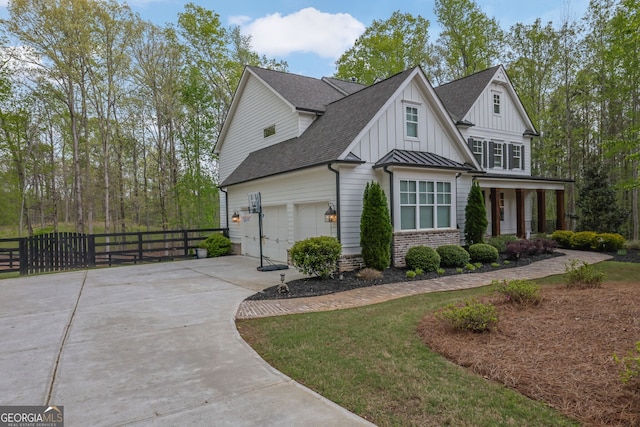123 Townsend Pass, Alpharetta, GA 30004 - view of front of home with concrete driveway, board and batten siding, a shingled roof, a standing seam roof, and covered porch