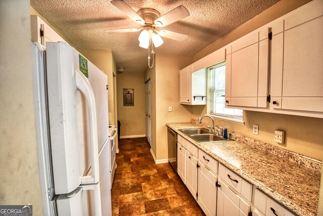 kitchen featuring light stone counters, white appliances, a textured ceiling, ceiling fan, and a sink