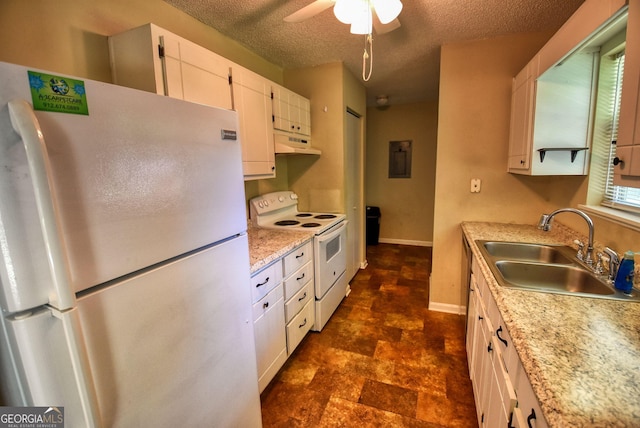 kitchen featuring white appliances, a textured ceiling, white cabinets, under cabinet range hood, and a sink