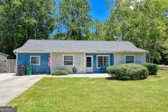 ranch-style home featuring a front yard and fence