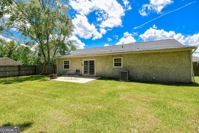 back of house with a patio, a yard, a fenced backyard, and stucco siding