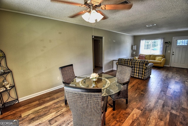 dining room featuring wood-type flooring, ceiling fan, and a textured ceiling