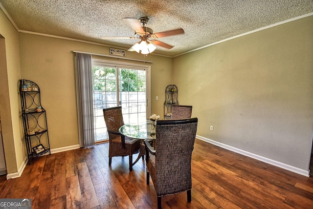 dining area featuring ornamental molding, ceiling fan, a textured ceiling, and dark wood-style floors