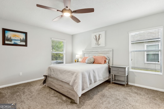 bedroom with light colored carpet, baseboards, and a ceiling fan