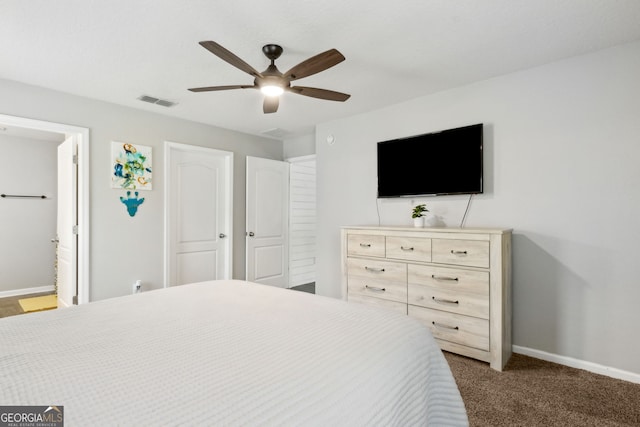 carpeted bedroom featuring ceiling fan, baseboards, visible vents, and ensuite bath