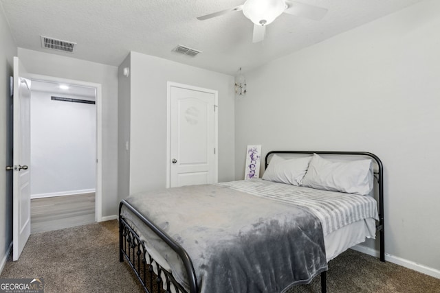 carpeted bedroom with ceiling fan, baseboards, and visible vents