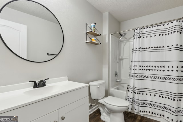 full bathroom featuring a textured ceiling, vanity, toilet, shower / bath combo, and wood finished floors