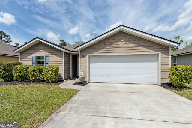 ranch-style house featuring an attached garage, concrete driveway, and a front yard