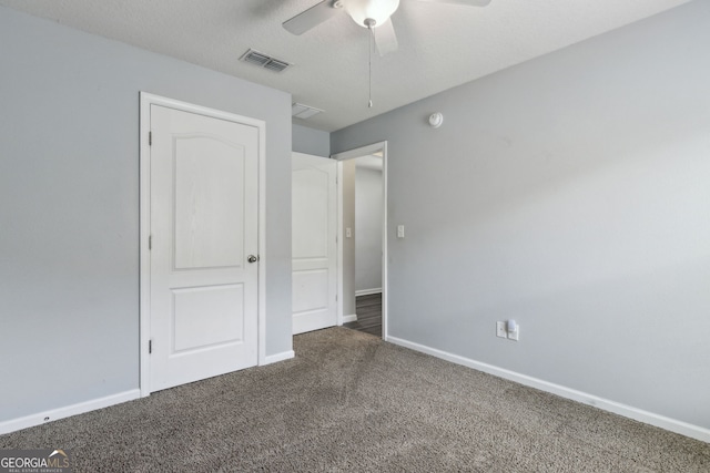 unfurnished bedroom with baseboards, a ceiling fan, visible vents, and carpet floors