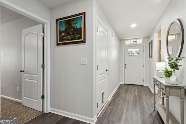 interior space with baseboards and wood finished floors