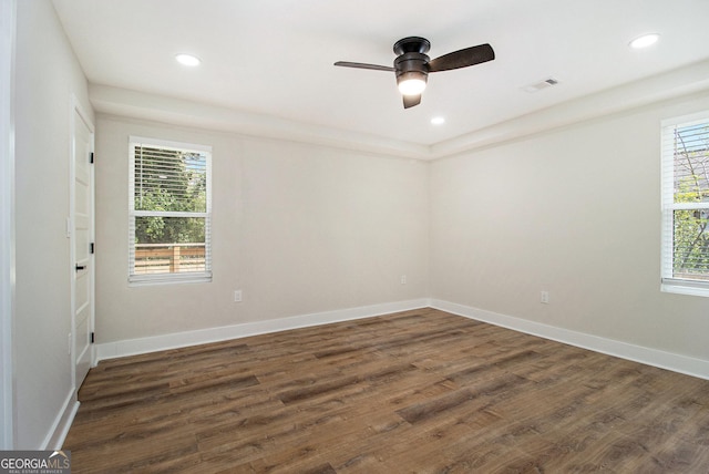spare room featuring dark wood finished floors, baseboards, ceiling fan, and recessed lighting