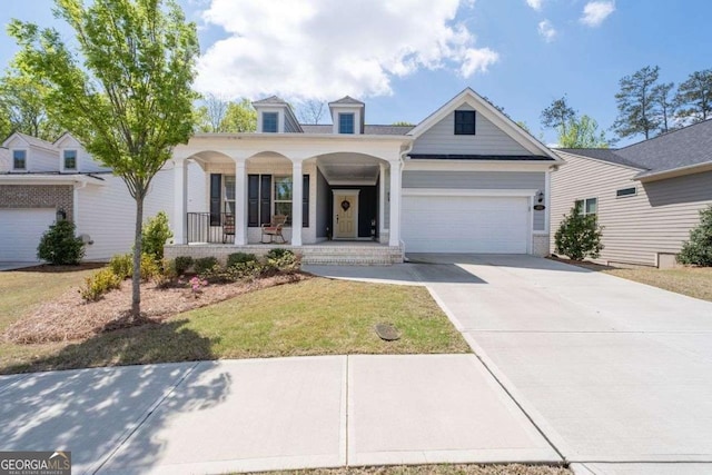 view of front of property featuring an attached garage, covered porch, and concrete driveway