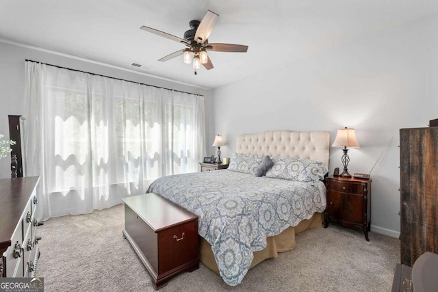 bedroom with light carpet, ceiling fan, baseboards, and visible vents