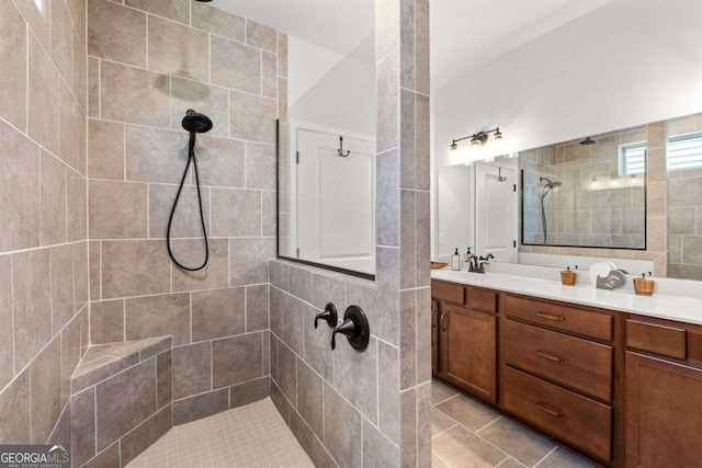 full bath with a walk in shower and vanity