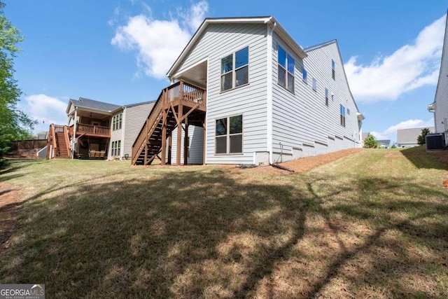 back of house with central air condition unit, a yard, a deck, and stairway