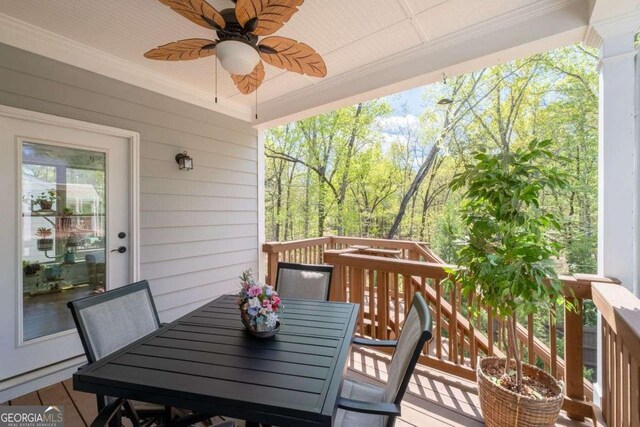 wooden deck featuring a ceiling fan and outdoor dining area