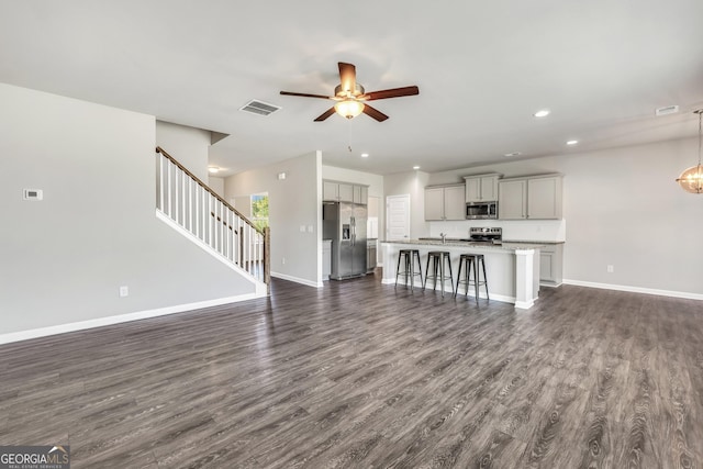 unfurnished living room featuring recessed lighting, dark wood-style flooring, baseboards, and ceiling fan
