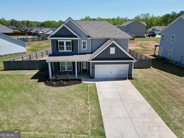 traditional-style home with concrete driveway, roof with shingles, a porch, and fence