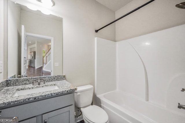 full bath featuring toilet, vanity, and bathtub / shower combination