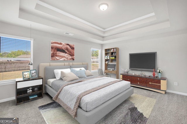 bedroom featuring crown molding, baseboards, a raised ceiling, and carpet flooring