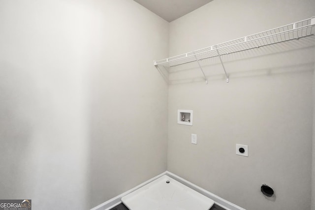 washroom featuring hookup for an electric dryer, laundry area, baseboards, and washer hookup