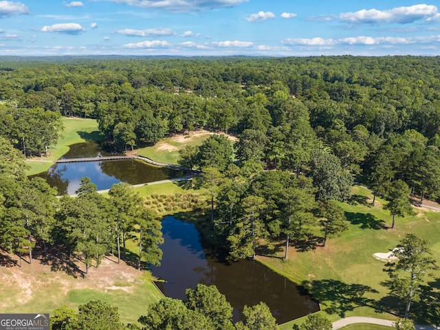 bird's eye view with a wooded view, golf course view, and a water view