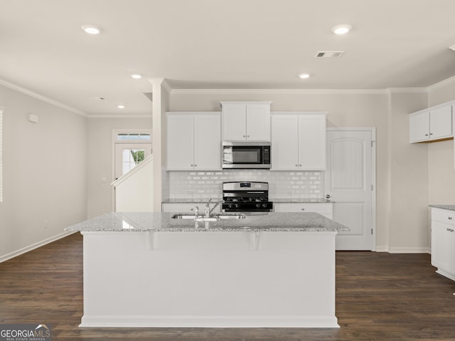kitchen featuring light stone counters, a sink, baseboards, and stainless steel appliances
