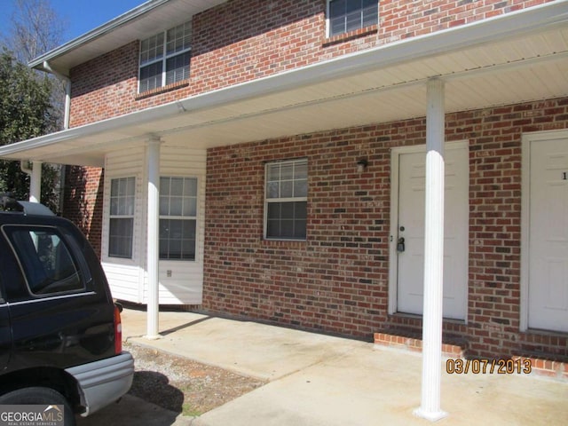 doorway to property with brick siding