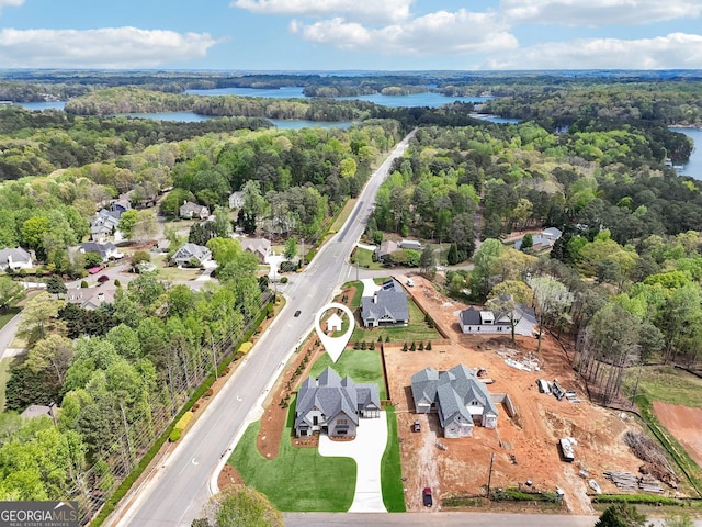 bird's eye view featuring a forest view, a residential view, and a water view