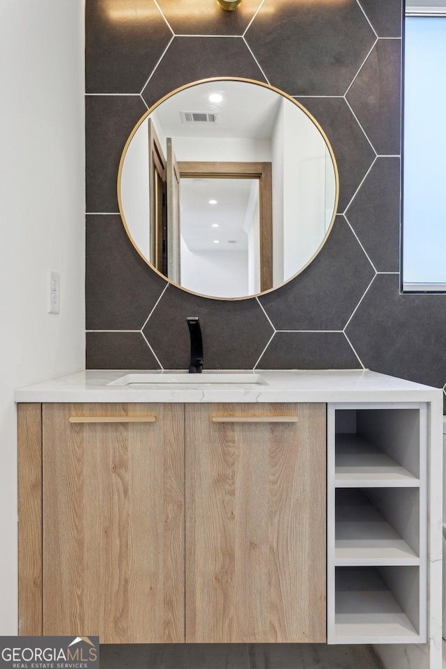 bathroom with vanity and visible vents