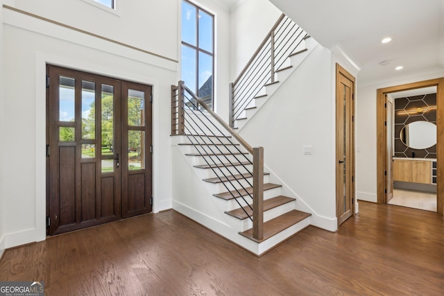 foyer featuring wood finished floors, baseboards, and a wealth of natural light