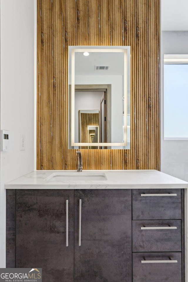bathroom featuring vanity and visible vents